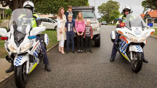 Motorcycle police help Ingrid Magtengaard and fellow olive oil pickers deliver their pressings. 